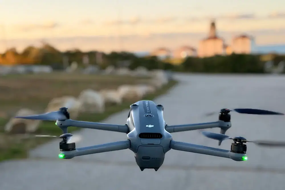 Drone capturing aerial footage over the ocean at sunset for cinematic video storytelling