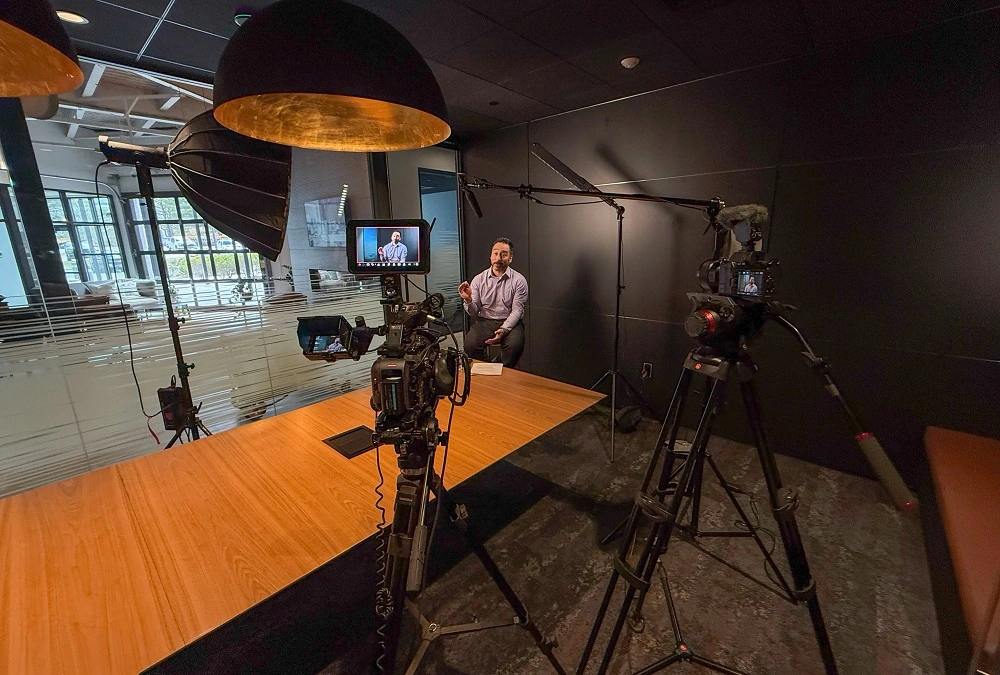 Young man being interviewed in front of a camera setup in Rhode Island