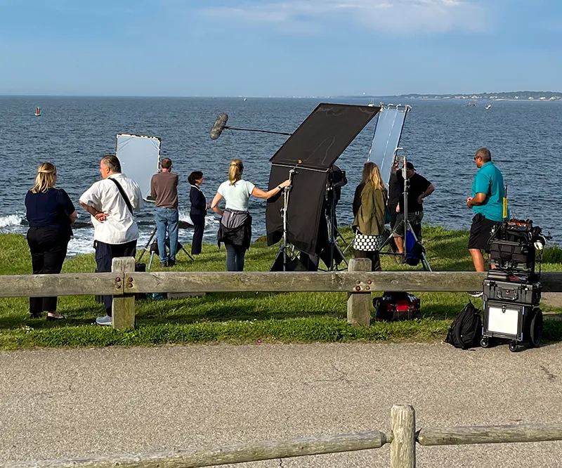 Video cameras filming corporate interview with speaker and reporters