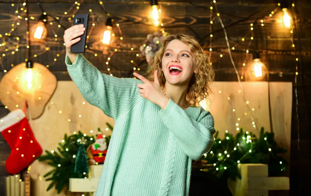 Woman taking a selfie video to post on TikTok Ads